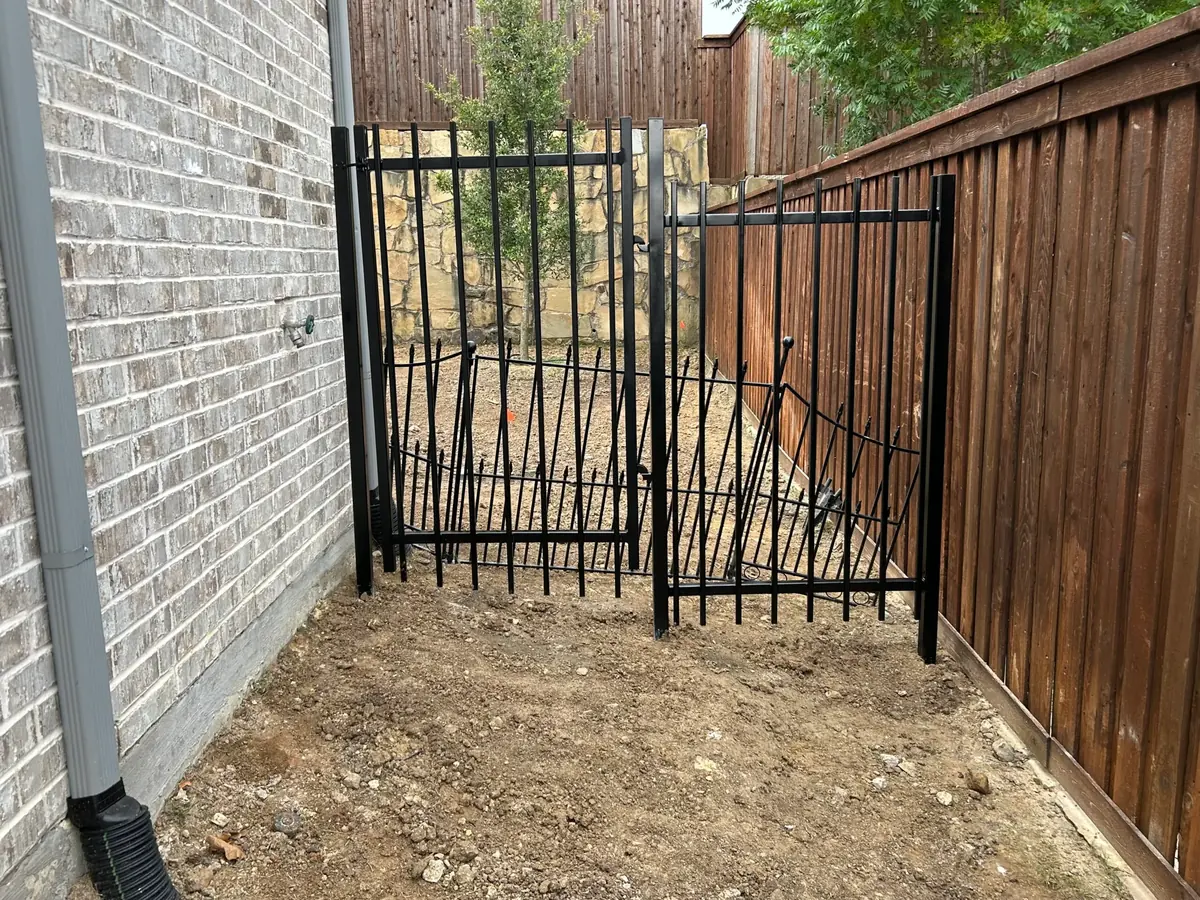 Custom residential side entry gate — heavy-gauge powder-coated steel, matched to an existing fence in McKinney