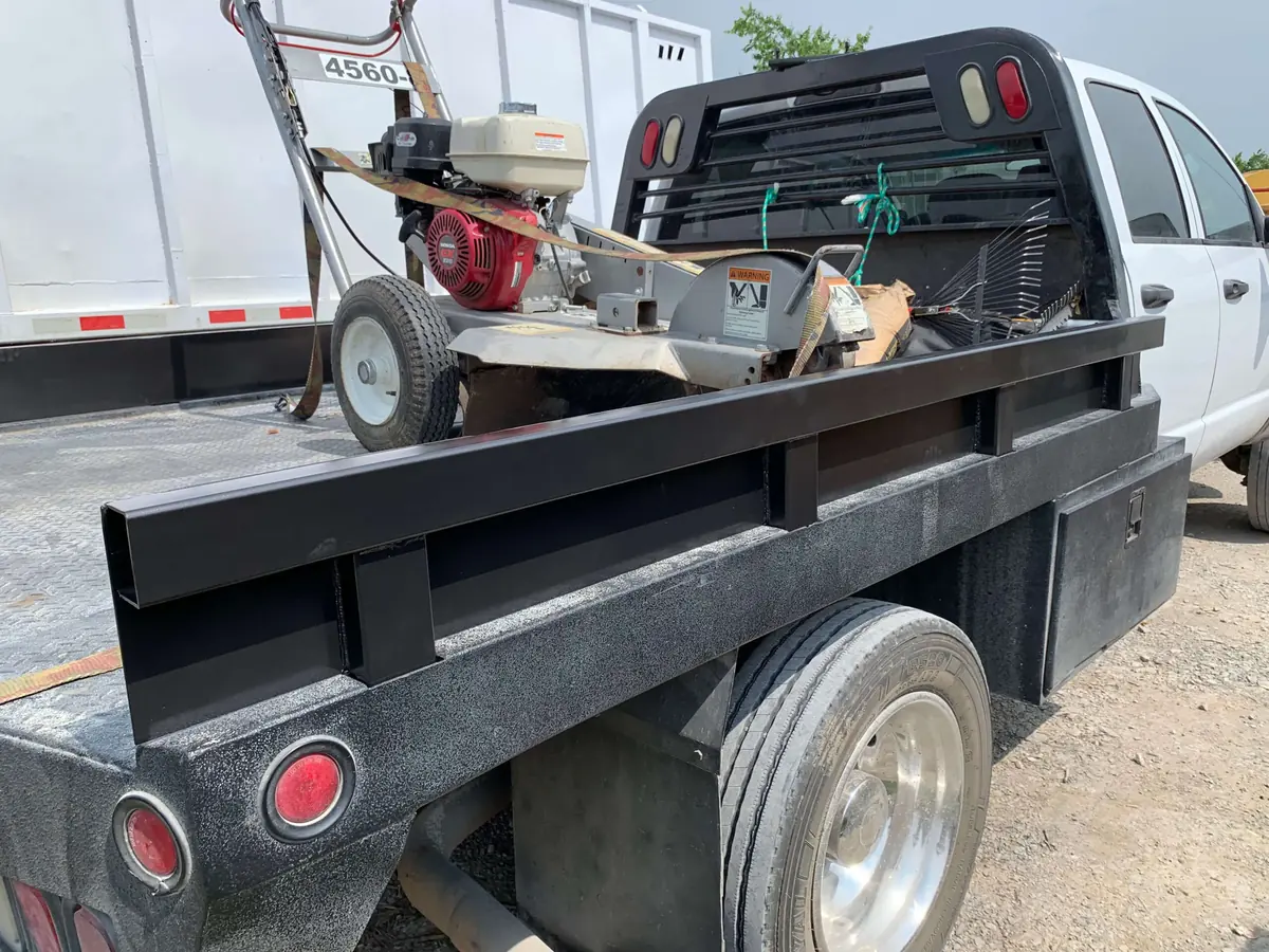 Custom steel side rails fabricated from heavy-gauge tubing and powder-coated for a flatbed work truck